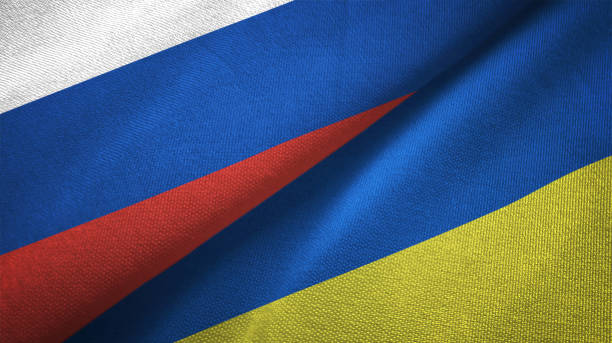 Ukraine and Russia two flags together realations textile cloth fabric texture stock photo