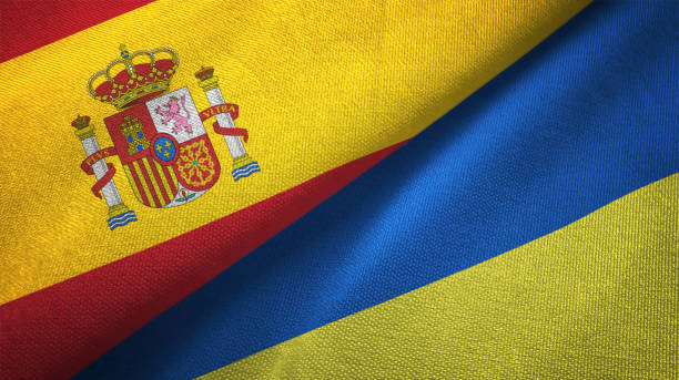 Ukraine and Spain two flags together realations textile cloth fabric texture stock photo