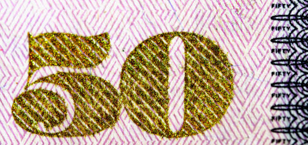 Ultra macro of the golden number 50 on the American 50 dollar bill stock photo