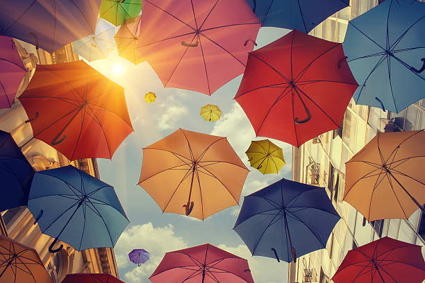 Umbrellas falling from the sky stock photo