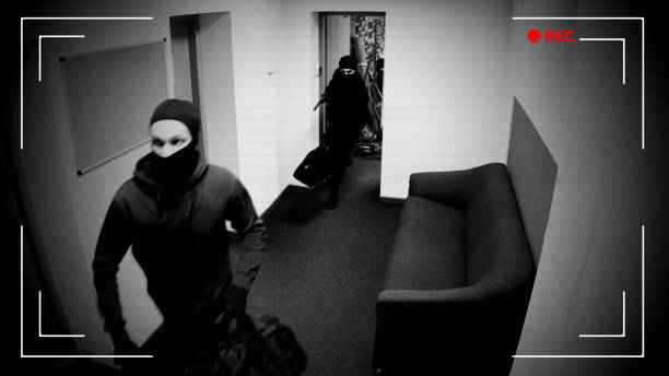 Undefined thieves escaping from place of crime, armed robbery, CCTV effect Undefined thieves escaping from place of crime, armed robbery, CCTV effect ski mask criminal stock pictures, royalty-free photos & images