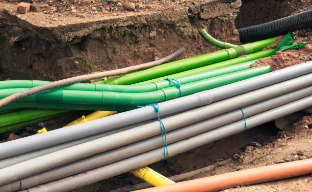 Underground pipe installation Engineering work: the installation of a large number of plastic pipes under the street. buried stock pictures, royalty-free photos & images