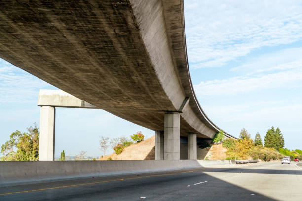 Underside view of freeway at a freeway interchange in East San Francisco bay area, California Underside view of freeway at a freeway interchange in East San Francisco bay area, California overpass road stock pictures, royalty-free photos & images