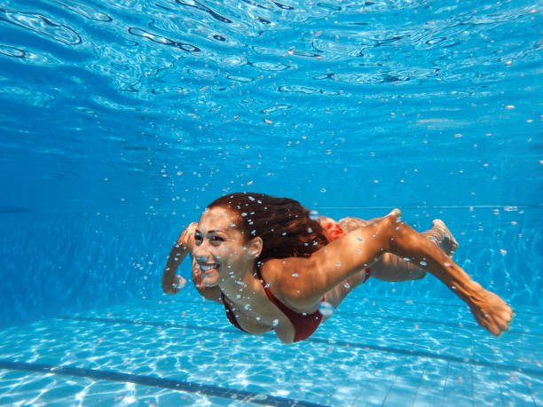 Underwater happiness Shot of a young woman swimming in the pool woman snorkeling stock pictures, royalty-free photos & images