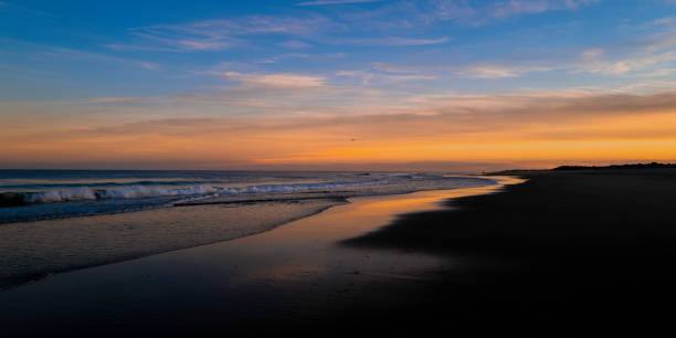 Undulating twilight beach hill seascape at Cape Cod National Seashore. stock photo