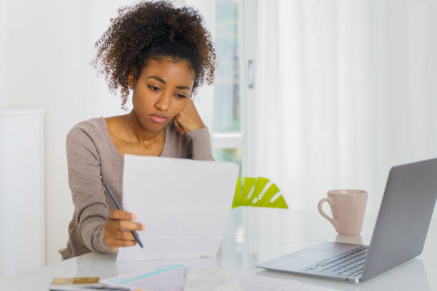 Unhappy black woman feel stressed working on computer at home Frustrated young woman with laptop working in home office student debt stock pictures, royalty-free photos & images