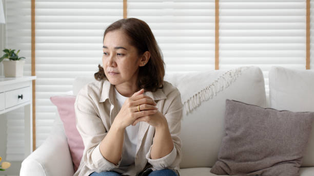 Unhappy Female employee latin mom think sit sofa couch at home living room need help support panic coronavirus financial debt crisis in life insurance feel pain distress pensive regret lost upset. stock photo