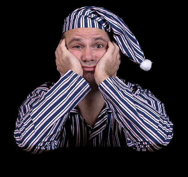 unhappy man in pajamas stock photo