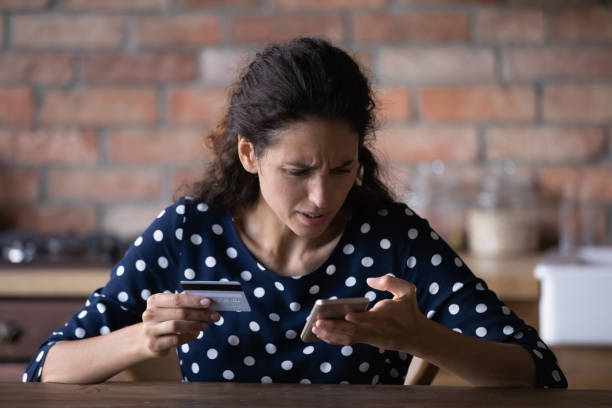 Unhappy woman have problems paying online on cell Unhappy young Caucasian female buyer have problems buying online on internet on smartphone with credit card. Angry frustrated woman confused with account money loss shopping on web on cellphone. scammer stock pictures, royalty-free photos & images