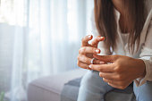 istock Unhappy woman holding wedding ring close up 1331249804