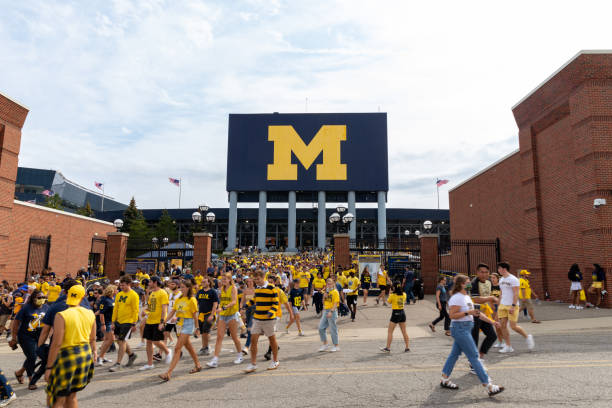 Unidentified Fans exit Michigan Stadium after a University of Michigan football game stock photo