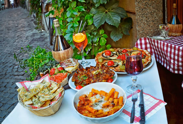 Unidentified people eating traditional italian food in outdoor restaurant stock photo