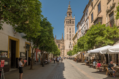 seville, spain-may, 17, 2022: Unidentified people walking down a street in the old town, Andalusia, Seville