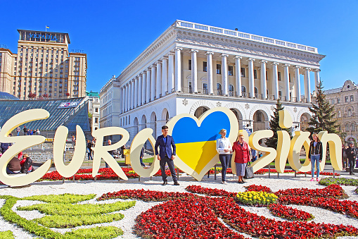 Kyiv, Ukraine - May 01, 2017: Unidentified tourists near part of official logo of Eurovision Song Contest 2017 on Maidan Nezalezhnosti (Independence Square)