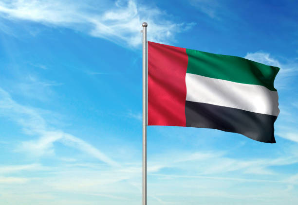 United Arab Emirates flag waving cloudy sky background United Arab Emirates flag on flagpole waving cloudy sky background realistic 3d illustration with copy space united arab emirates flag stock pictures, royalty-free photos & images