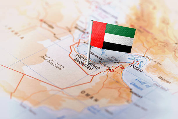 The flag of United Arab Emirates pinned on the map. Horizontal orientation. Macro photography.