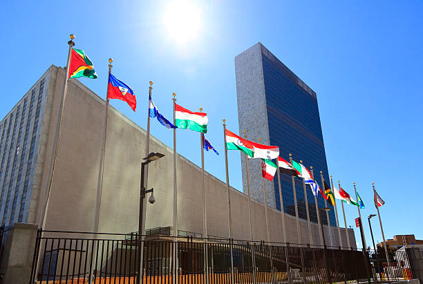 United Nations Headquarters with waving flags in New York, USA stock photo