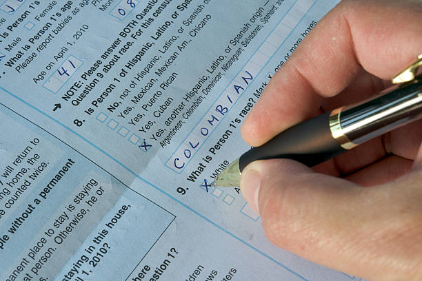 United States Census 2010 Hand of a man answering answering the United States Census 2010. He's marking "White" when asked the person's race. He's already indicated that he is Latino, Colombian. Male. census stock pictures, royalty-free photos & images