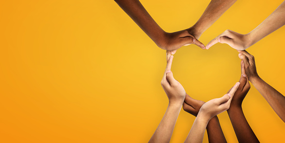 Unity and diversity are at the heart of a diverse group of people connected together as a supportive symbol that represents a sense of and togetherness. Symbol and shape created from hands.