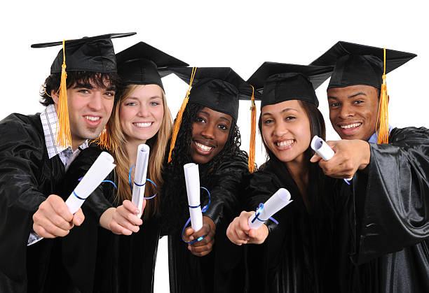 University Graduates Diverse group of university graduates wearing graduation gowns.   2009 stock pictures, royalty-free photos & images
