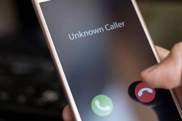 Unknown caller. A man holds a phone in his hand and thinks to end the call. Incoming from an unknown number. Incognito or anonymous Unknown caller. A man holds a phone in his hand and thinks to end the call. Incoming from an unknown number. Incognito or anonymous mystery stock pictures, royalty-free photos & images