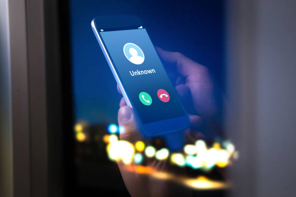 Unknown number calling in the middle of the night. Phone call from stranger. Unknown number calling in the middle of the night. Phone call from stranger. Person holding mobile and smartphone home late. scammer stock pictures, royalty-free photos & images