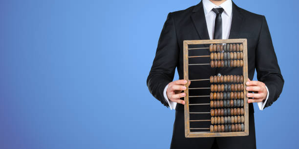 Unrecognizable businessman showing you a vintage abacus. Business concept Unrecognizable businessman showing you a vintage abacus. Business concept abacus stock pictures, royalty-free photos & images