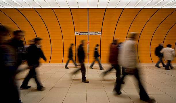 unrecognizable commuters at an orange underground stock photo