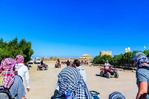 Unrecognizable people driving quad bikes during safari trip in Arabian desert not far from the Hurghada city, Egypt Hurghada, Egypt - December 10, 2018: Unrecognizable people driving quad bikes during safari trip in Arabian desert not far from the Hurghada city, Egypt hot egyptian women stock pictures, royalty-free photos & images