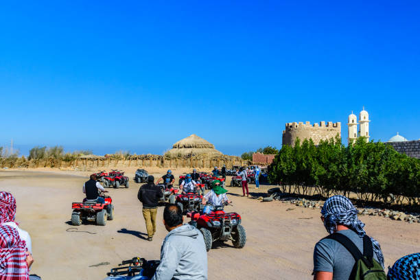 Unrecognizable people driving quad bikes during safari trip in Arabian desert not far from the Hurghada city, Egypt Hurghada, Egypt - December 10, 2018: Unrecognizable people driving quad bikes during safari trip in Arabian desert not far from the Hurghada city, Egypt hot egyptian women stock pictures, royalty-free photos & images