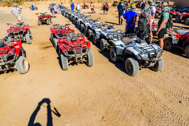 Unrecognizable people near quad bikes during safari trip in Arabian desert not far from the Hurghada city, Egypt Hurghada, Egypt - December 10, 2018: Unrecognizable people near quad bikes during safari trip in Arabian desert not far from Hurghada city, Egypt hot egyptian women stock pictures, royalty-free photos & images