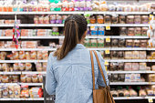 istock Unrecognizable woman marvels at grocery bread selection 1041147560