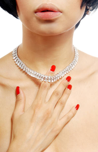 Unrecognizable woman showing off brilliant necklace on her neck stock photo