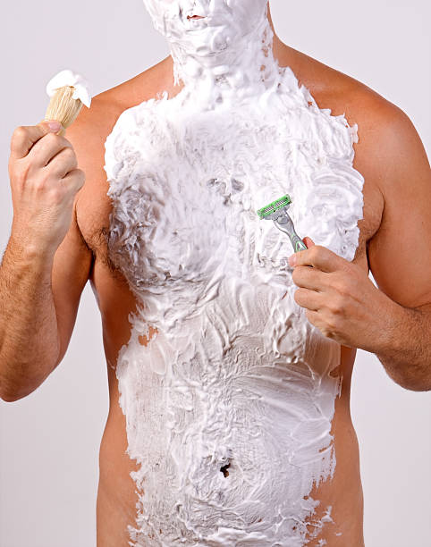 unshaved man with foam stock photo