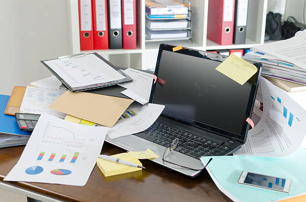 Untidy and cluttered desk stock photo