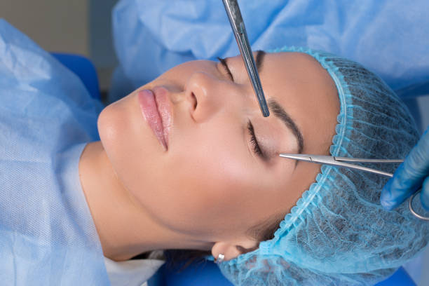 Upper eyelid blepharoplasty Upper eyelid blepharoplasty. Beautiful middle age woman getting ready for eyelid lift plastic surgery doctor hands in blue gloves point medical tools to her eye. Beauty, people and health concept lid stock pictures, royalty-free photos & images
