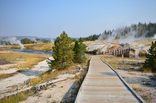View of a bridge crossing the Firehole River at Upper Geyser Basin, Old Faithful, Yellowstone