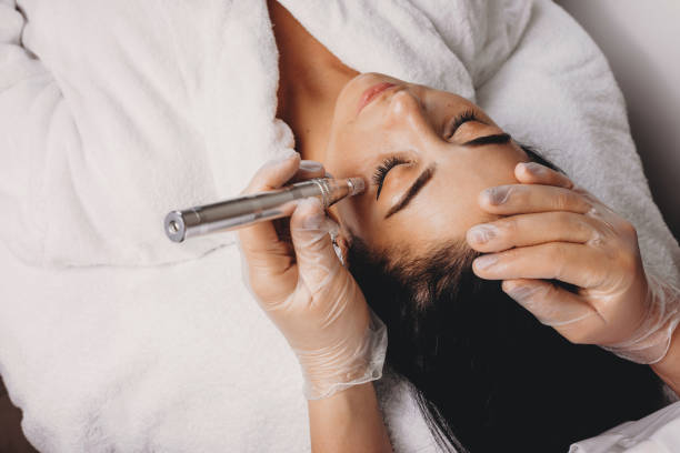 Upper view of ca skin care procedure made with modern apparatus at the spa salon stock photo