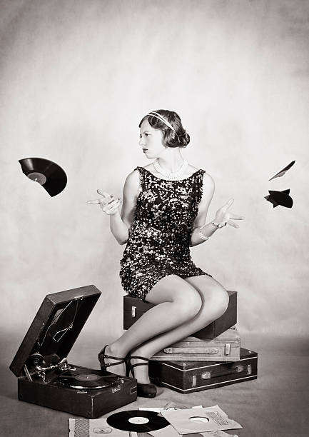 Upset girl scatters shards of broken gramophone records The picture was taken in a home studio photographer. girls in very short dresses stock pictures, royalty-free photos & images