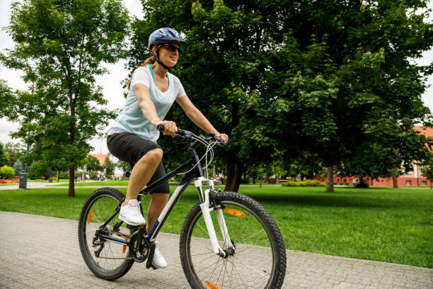 Urban biking- woman riding bike in city stock photo
