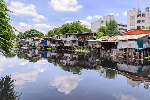 Urban ghetto house village canal side in Bangkok Thailand. stock photo