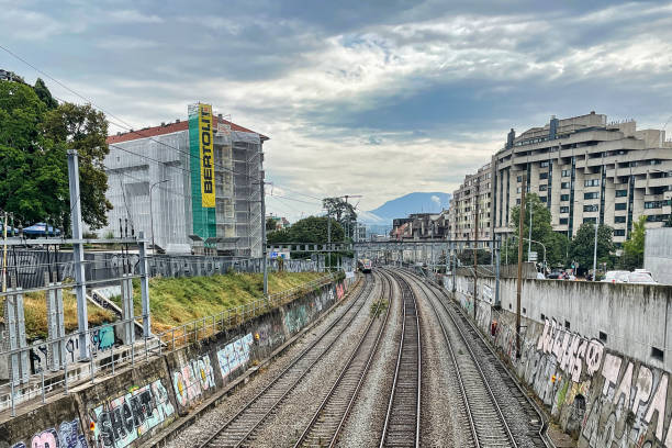 urban train tracks in geneva Geneva, Switzerland - September 15 2021: an urban view of train tracks leading into the city and connecting it to the national network rough endoplasmic reticulum stock pictures, royalty-free photos & images