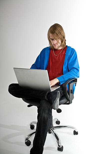 using laptop in chair stock photo