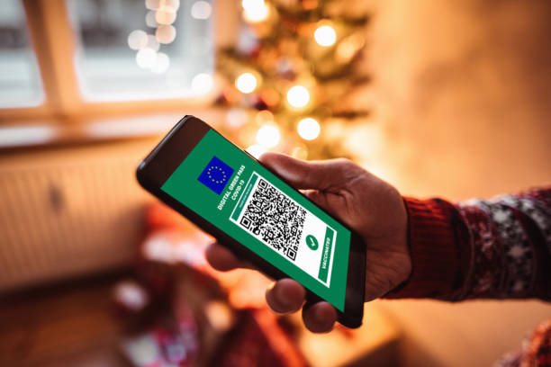 using the covid green pass at home for christmas launch stock photo
