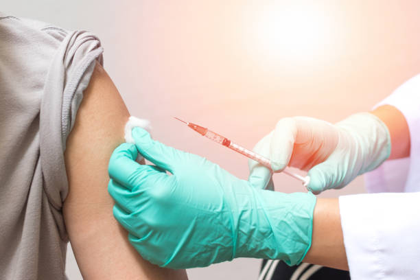 aşı sağlık kavramı. doktor veya hemşire tıbbi eldiven bir doz aşı bir adam hasta için enjekte - vaccine stok fotoğraflar ve resimler