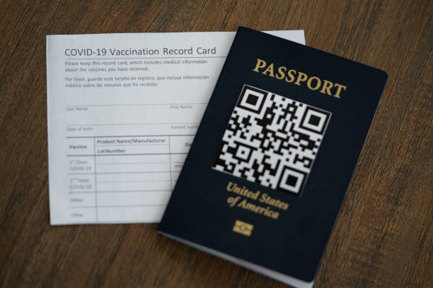 COVID-19 Vaccination record card next to the QR code Passport of USA. Travel concept during pandemic COVID-19 Vaccination record card next to the QR code Passport of USA. Travel concept during pandemic cdc vaccine card stock pictures, royalty-free photos & images