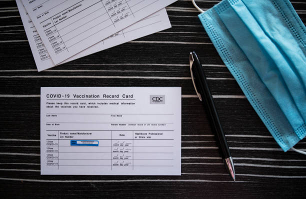 COVID-19 Vaccination Record Card. Directly above of COVID-19 vaccination record card. cdc vaccine card stock pictures, royalty-free photos & images