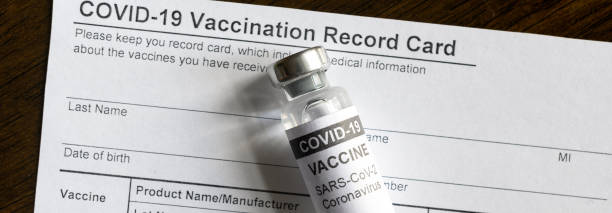 COVID-19 vaccine bottle on coronavirus Vaccination Record Card COVID-19 vaccine bottle on coronavirus Vaccination Record Card, panoramic banner with corona virus vaccine and immunization certificate. Concept of COVID pandemic, safety and travel. cdc vaccine card stock pictures, royalty-free photos & images