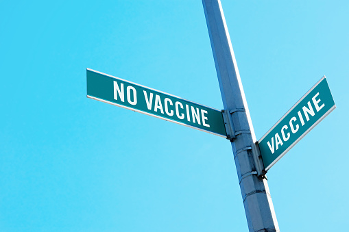 Road sign symbolizing decision between vaccine or no vaccine