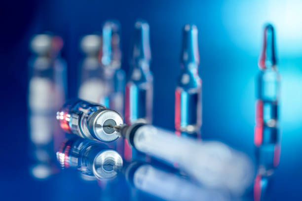 Vaccines and syringe in a laboratory stock photo